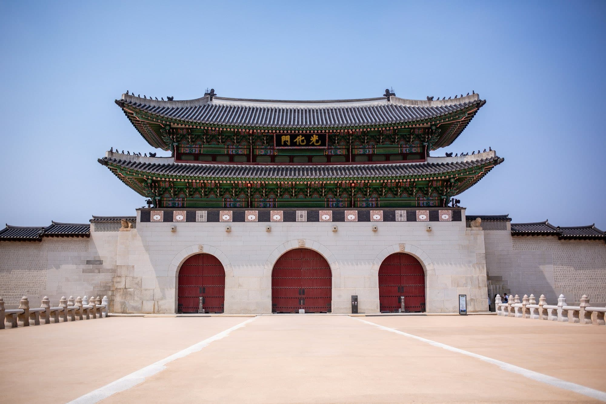 Gwanghwamun gate facade under a clear blue sky in Seoul